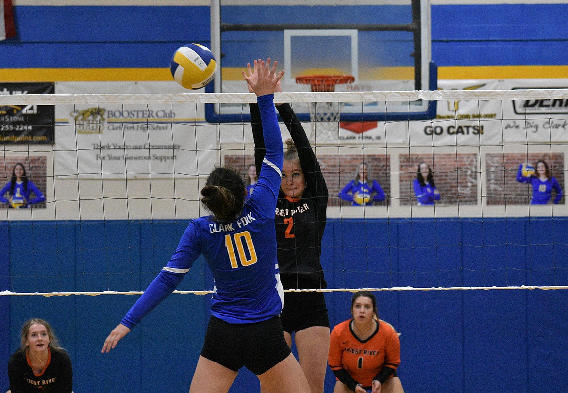Sophomore Ethnee White tries to block a kill by Clark Fork's Caiya Yanik on Sept. 19.