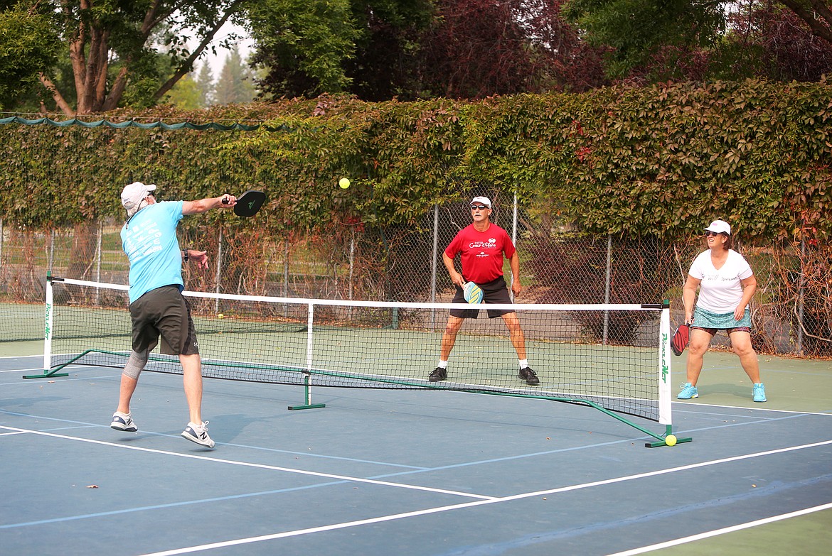 A group p;lays doubles on the pickleball courts at the Montana Athletic Club in Bigfork.