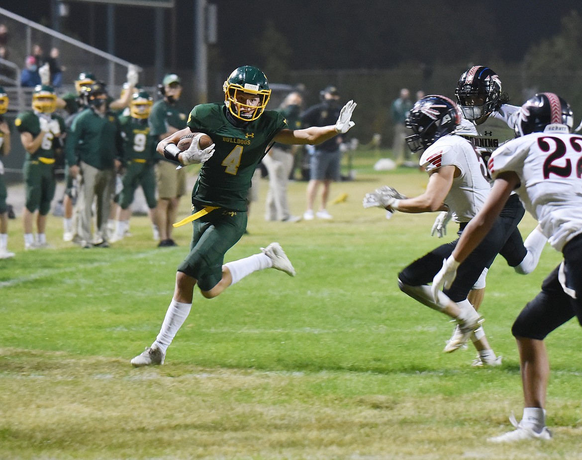 Bulldog junior Jaxsen Schlauch makes a run past the Browning defense Thursday night at the Dawg Pound. (Heidi Desch/Whitefish Pilot)