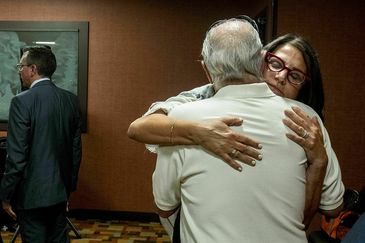 FILE - In this July 11, 2019 file photo, Tanya Gersh, a Montana real estate agent, embraces her father Lloyd Rosenstein following a hearing at the Russell Smith Federal Courthouse in Missoula. The real estate agent’s attorneys are eyeing the assets of a neo-Nazi website operator to collect on a $14 million court judgment against the man for an anti-Semitic harassment campaign that he orchestrated online against the Jewish woman and her family. (Ben Allen/The Missoulian via AP)