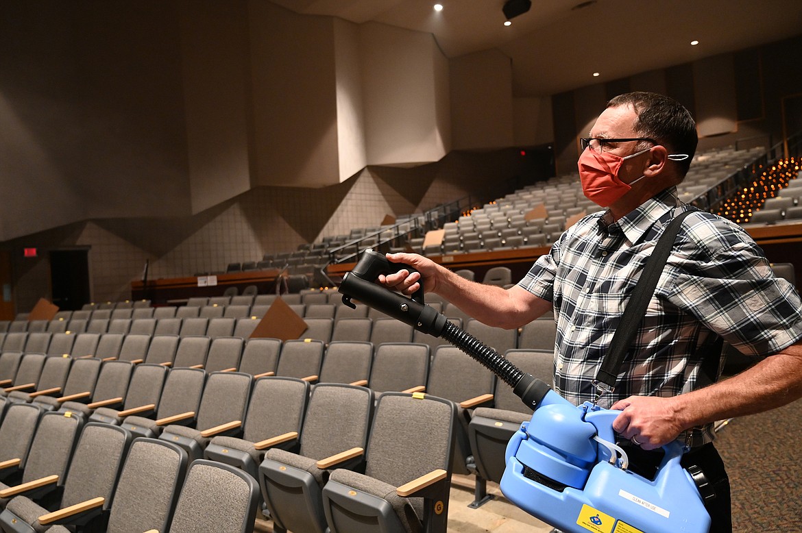 Garry Stark, North Idaho College director of facilities operations, uses a portable fogging machine to spray a hypochlorous acid solution in the NIC Schuler Performing Arts Center on Sept. 18. The substance quickly, effectively, and safely deactivates the virus that causes COVID-19.