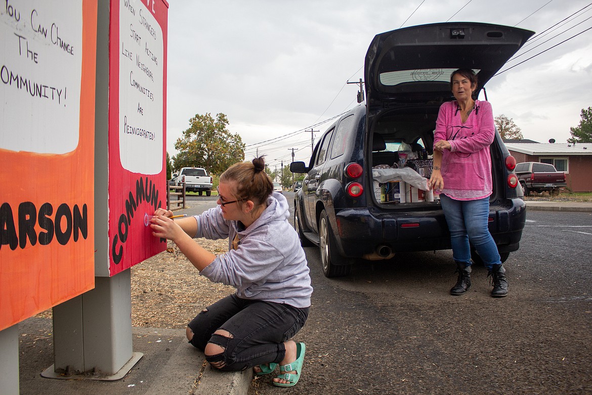 Jaymee Welch works on some final touches for a mailbox canvas in the Larson community in Moses Lake on Wednesday afternoon, Sept. 23, as her mom, Christy Welch watches her project come together.