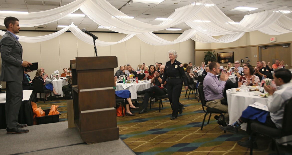 Applause all around as Post Falls Police Chaplain Jacque Panza makes her way to the lectern Wednesday during the Coeur d'Alene Regional Chamber of Commerce's inaugural Public Safety Awards Luncheon in the Best Western Plus Coeur d'Alene Inn.