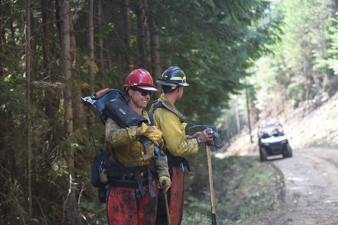 Ana-Leigh Avery and Daniel Gray, firefighters with a short haul helicopter based out of Helena, look for snags as part of efforts to mop up the Callahan Fire on Sept. 22.