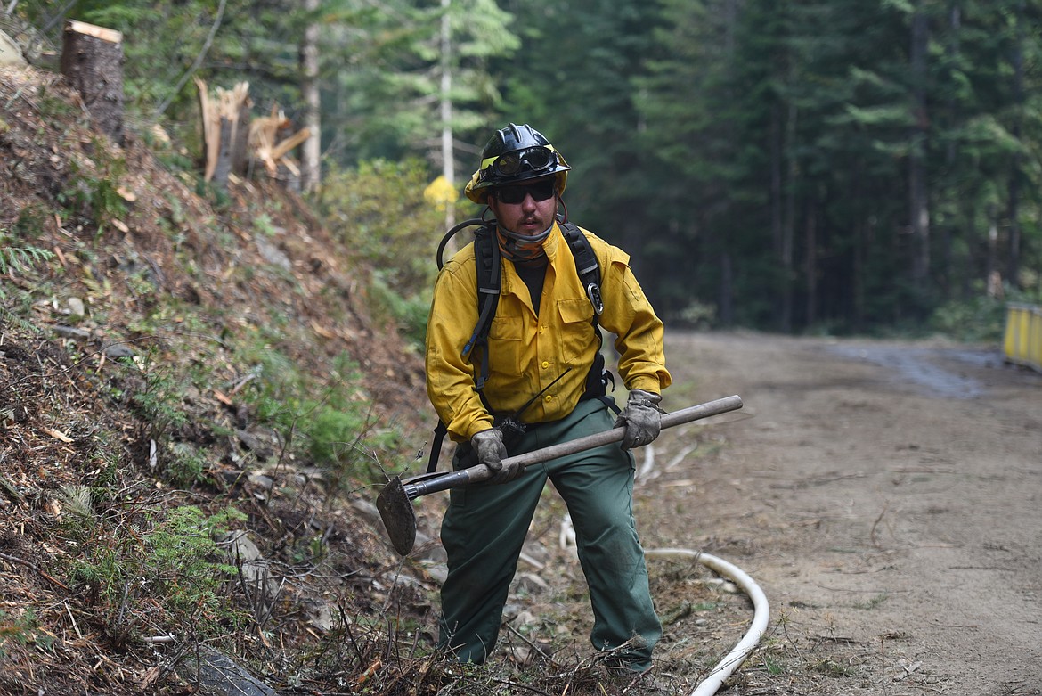 Engine boss Corey Graham from Eureka works along the edge of the Callahan Fire as part of mop up efforts on Sept. 22.