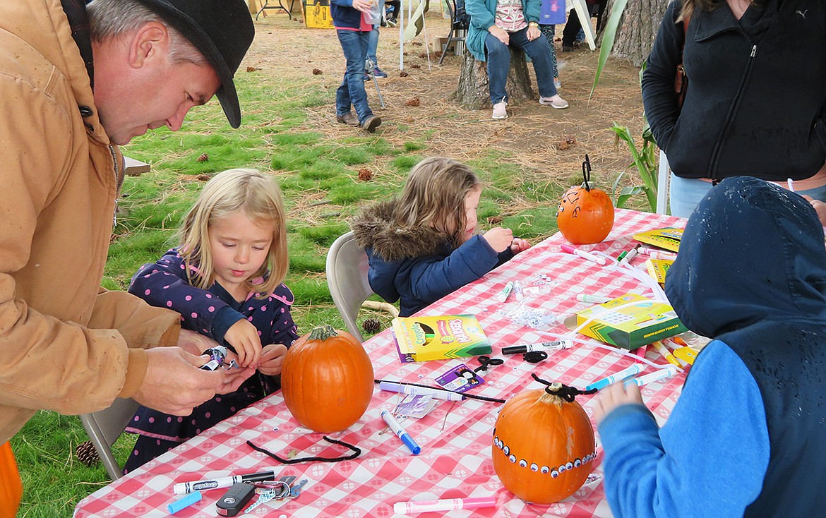 Pumpkin decorating is one of several fun activities for kids at the Athol Farmers Market Fall and Music Fest, taking place today from 2 to 7. Children are seen here carving up fun at last year's event.