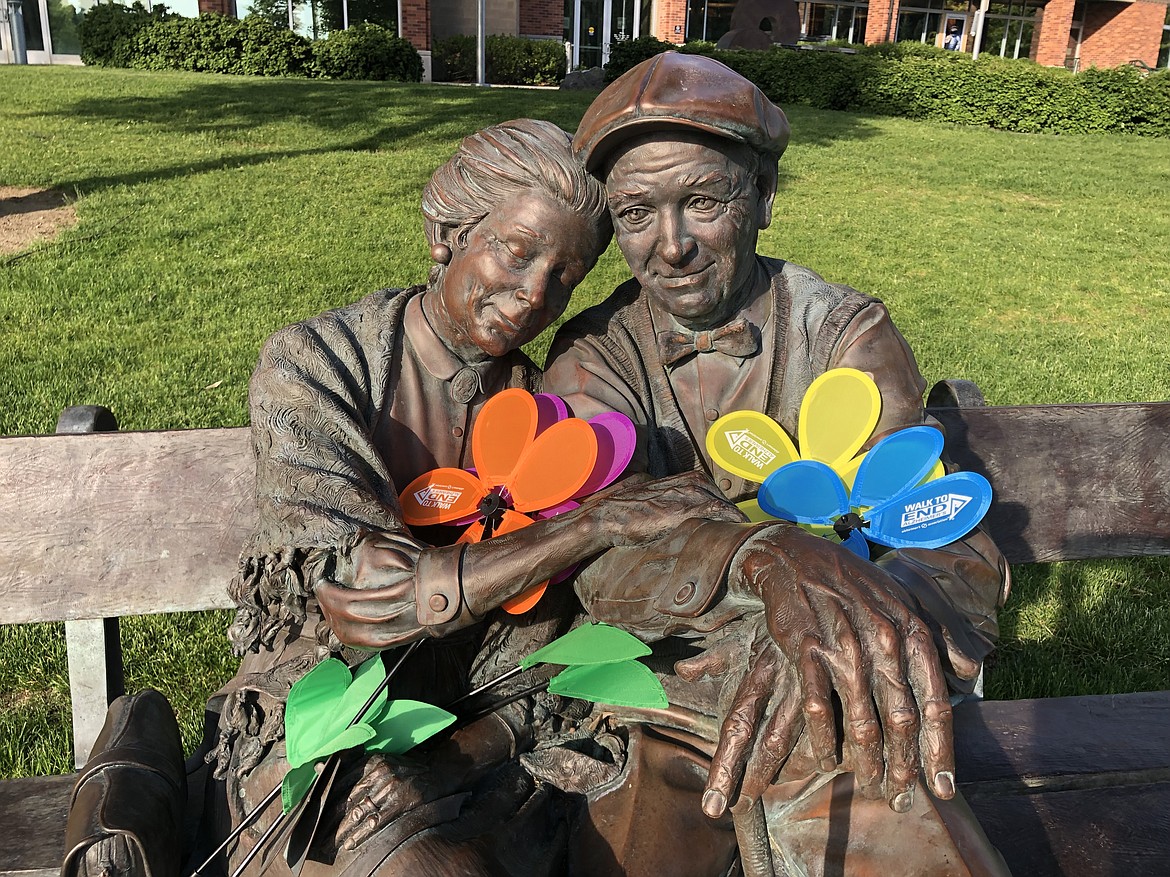 "The Valentine" statue in McEuen Park is decorated with Promise Garden flowers during the 2019 Walk to End Alzheimer's. The flowers represent different stages of the disease and caregivers. This year's walk is Saturday.