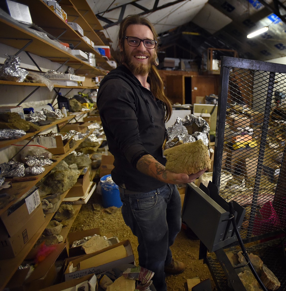 Inside his workshop between Columbia Falls and Whitefish, local fossil hunter Aamon Jaeger shows off the nose horn of a recently found ceratopsian specimen. (Jeremy Weber/Daily Inter Lake)