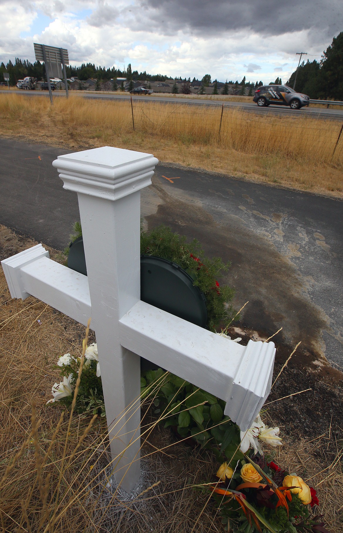 A memorial of a cross and flowers stands on the North Idaho Centennial Trail near the site of a fatal crash on Sept. 11 on Interstate 90. A preliminary hearing scheduled today for Christine M. Cann, 57, of Coeur d’Alene, the driver charged with felony vehicular manslaughter in the case, was rescheduled for Oct. 6. The head-on collision killed Jeremy T. Scherer, 24, of Spokane Valley. Police said Cann said drove west in the eastbound lanes I-90 in a 2020 Toyota RAV4 before striking Scherer's Chevy Sonic about 12:30 p.m. Cann was arrested later that night and remains at the Kootenai County jail on $75,000 bail. Investigators with Idaho State Police and the Kootenai County Prosecutors Office have asked anyone who witnessed the crash to contact ISP at 208-209-8730.