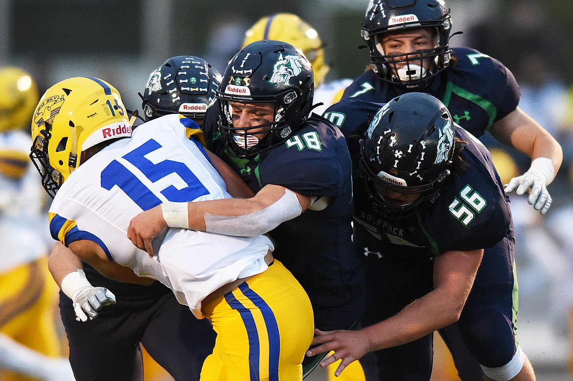 Glacier defenders AJ Wood (48) and Rocco Beccari (56) bring down Missoula Big Sky running back Hunter Meinzen (15) in the first half at Legends Stadium on Friday. (Casey Kreider/Daily Inter Lake)