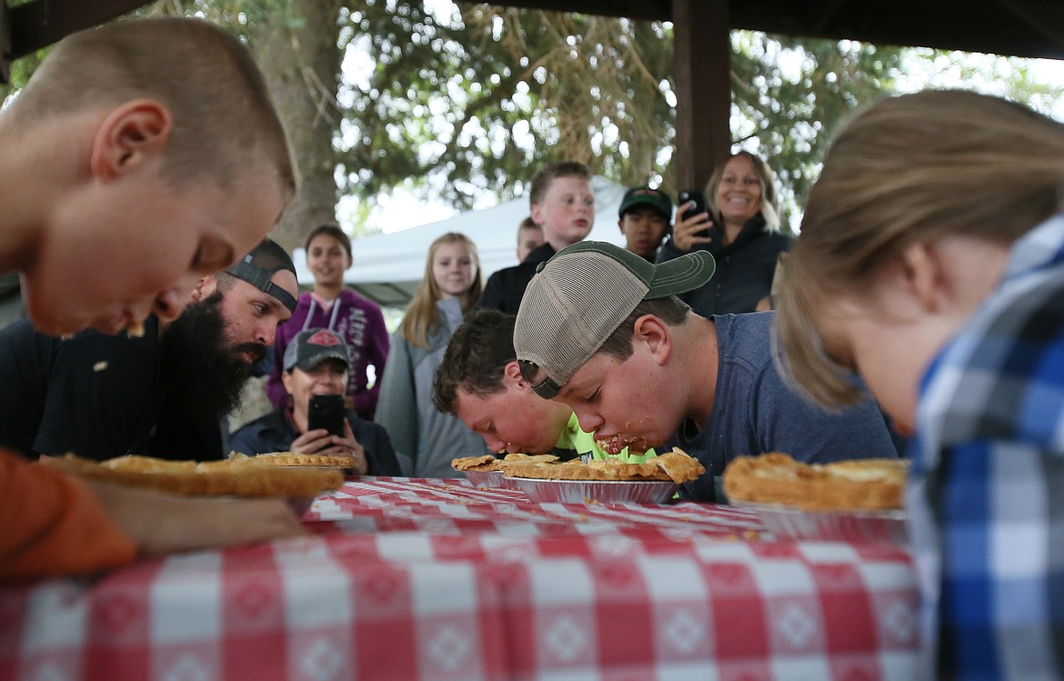 Pie eating contest winner Gabriel Thompson, 11, of Athol, means business with his hat flipped backward as he chows his way to victory Friday at the Athol Farmers Market Fall and Music Fest.