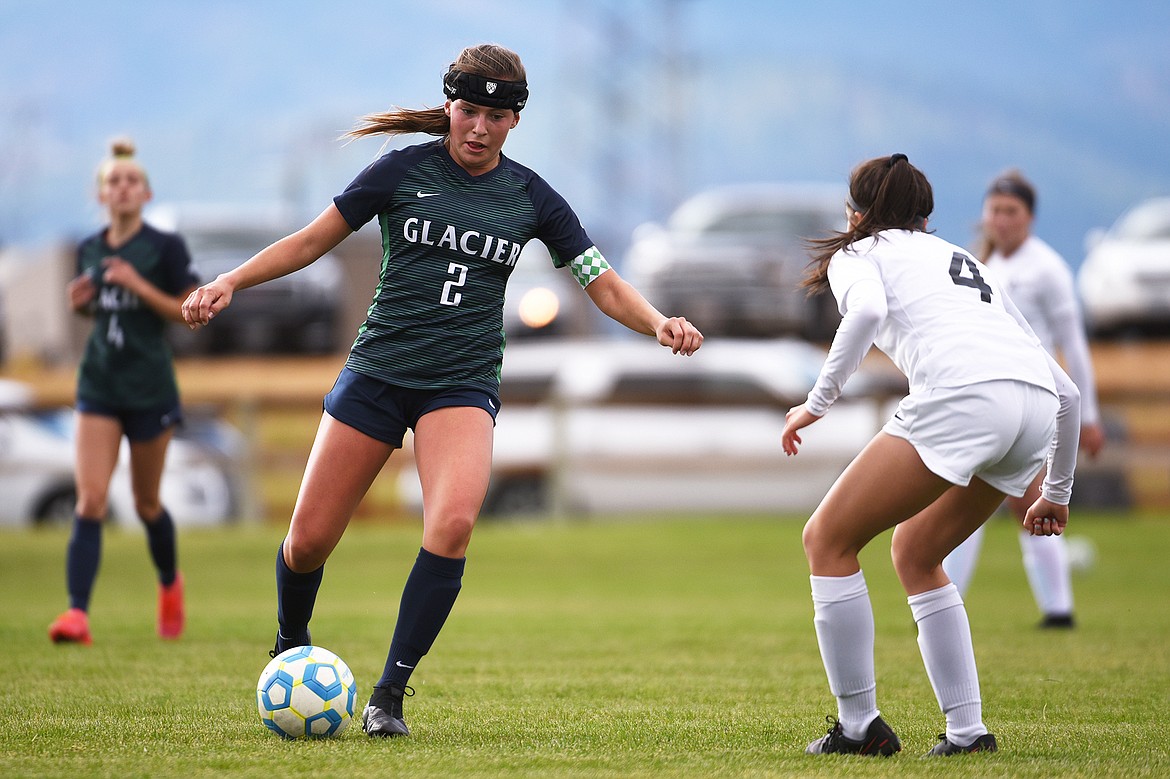 Glacier’s Emily Cleveland (2) works the ball upfield against Helena Capital’s Vivian Schuma (4) at Glacier High School on Saturday. (Casey Kreider/Daily Inter Lake)