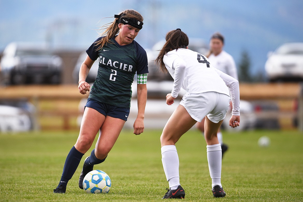 Glacier’s Emily Cleveland (2) works the ball upfield against Helena Capital’s Vivian Schuma (4) at Glacier High School on Saturday. (Casey Kreider/Daily Inter Lake)