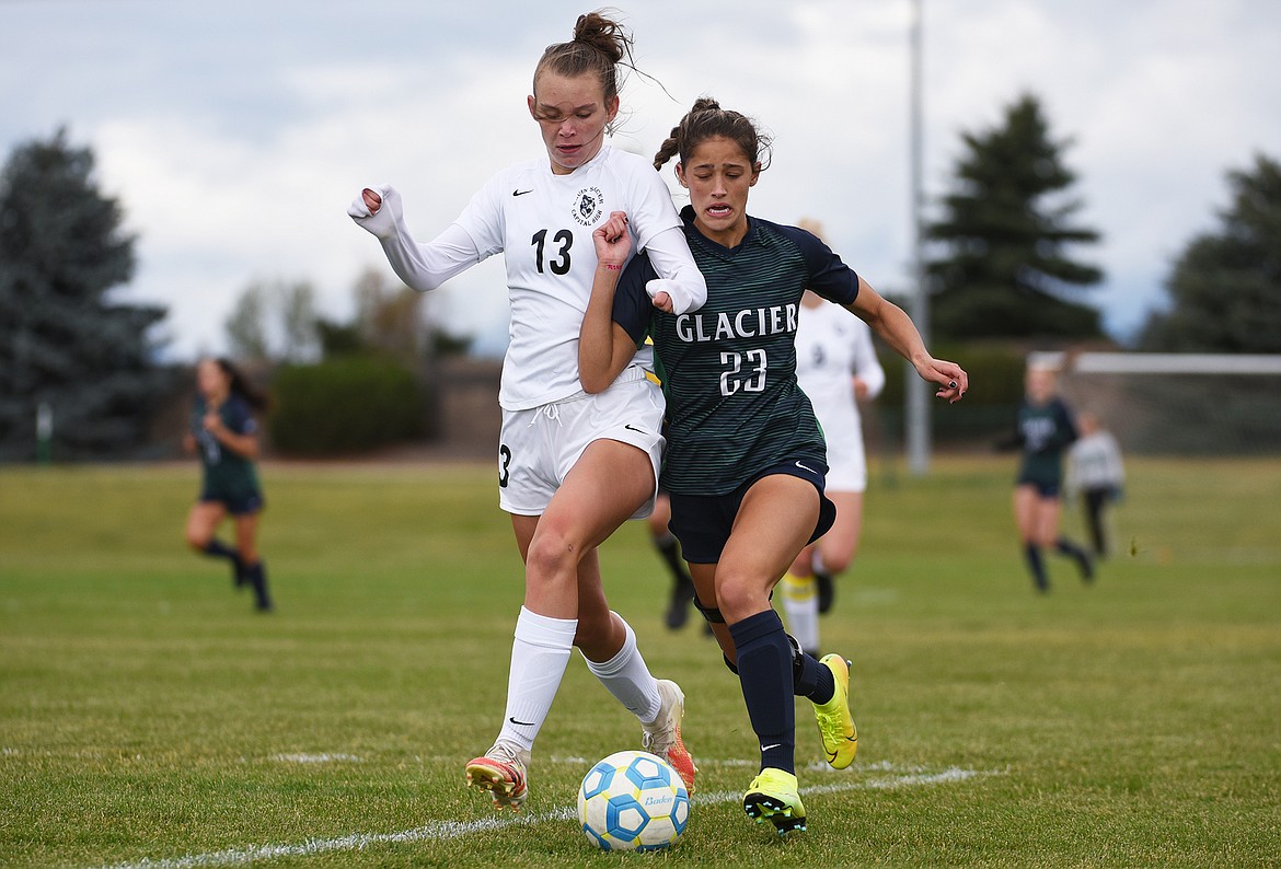 Glacier’s Taylor Brisendine (23) battles for possession with Helena Capital’s Rylee Cummings at Glacier High School on Saturday. (Casey Kreider/Daily Inter Lake)