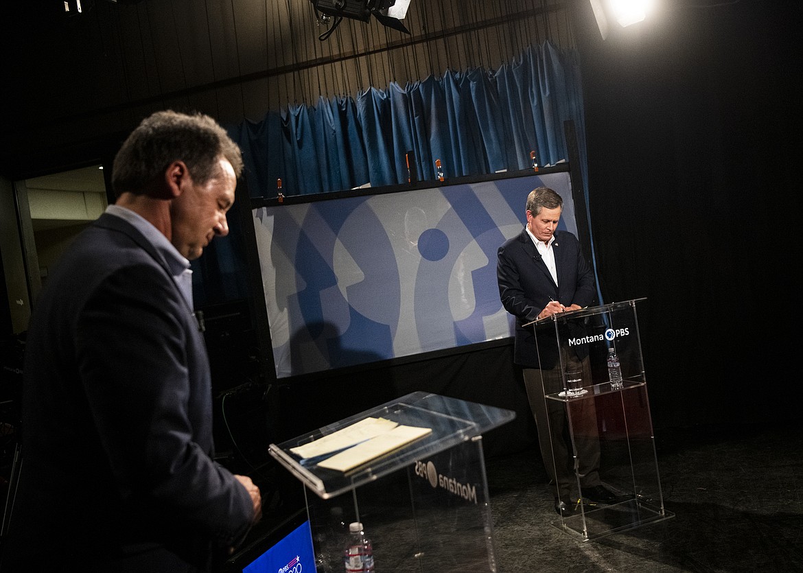 Gov. Steve Bullock, left, and U.S. Sen. Steve Daines, R-Mont., prepare their notes before the beginning of their televised debate at the KUFM-TV studio at the University of Montana on Monday, Sept. 28, 2020, in Missoula, Mont. (Ben Allan Smith/The Missoulian via AP)