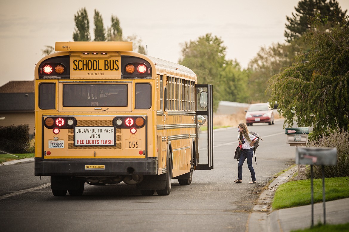 Paisley Ashton hops on the bus during one of the two days a week that she attends in-person classes at her middle school in Moses Lake.