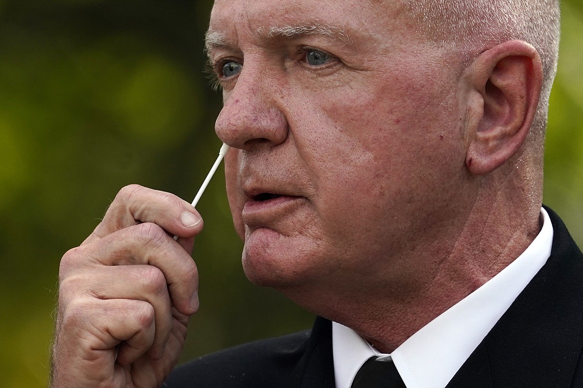 Adm. Brett Giroir, assistant secretary of Health and Human Services, swabs his nose as he demonstrates a new fast result COVID-19 test during a event with President Donald Trump about coronavirus testing in the Rose Garden of the White House, Monday, Sept. 28, 2020, in Washington.