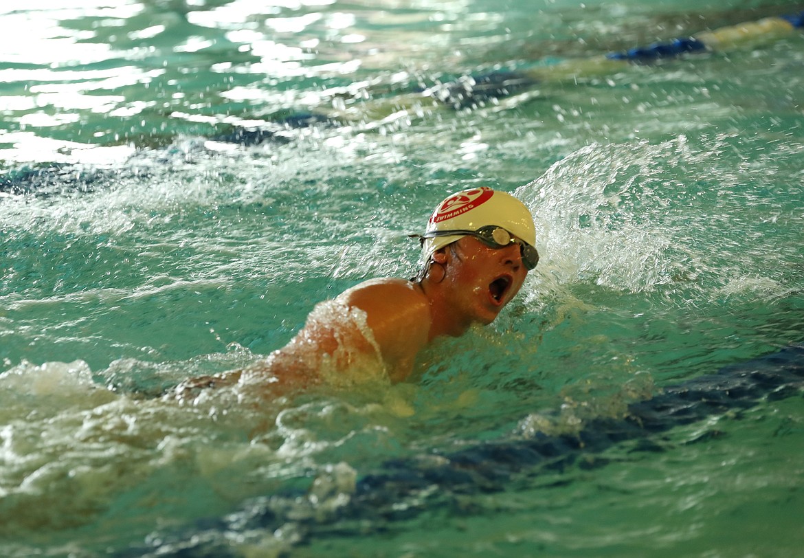 Senior Neal Causey swims in the 200 medley relay on Saturday.