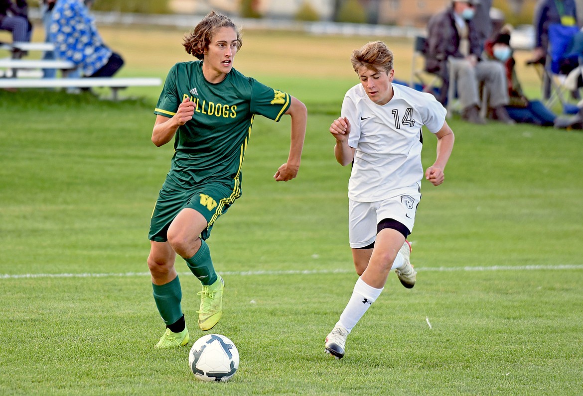 Bulldog midfielder Gabe Menicke beats his defender down the line as he looks for the cross in a game against Stevensville at Smith Fields on Thursday, Sept. 24. (Whitney England/Whitefish Pilot)