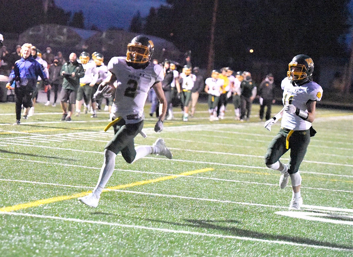 Bulldog Bodie Smith (2) heads for the end zone after taking a slant pass the length of the field late in the first half as teammate Jack Akey (11) follows Friday night in Ronan. (Scot Heisel/Lake County Leader)