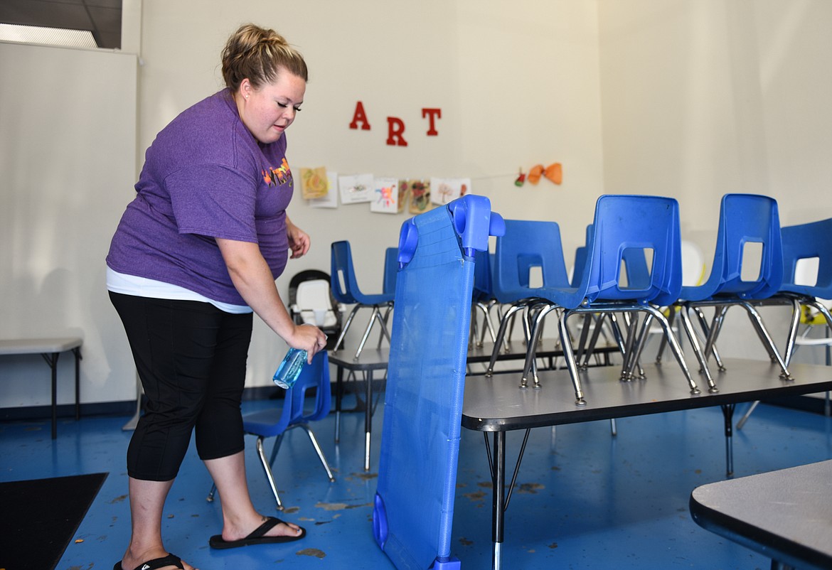 Brittney Malley sanitizes cots for kids to sit on while they watch movies and do activities at Scribbles Drop In Playcare in Kalispell on Tuesday, Sept. 29. (Casey Kreider/Daily Inter Lake)