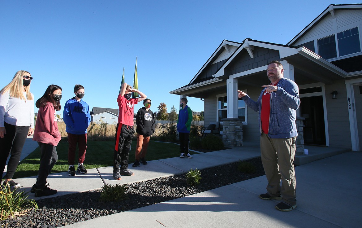 Greenstone Homes customer service specialist Jason Blessinger prepares Woodland Middle Schoolers for a tour of a newly constructed home during a field trip Tuesday morning.