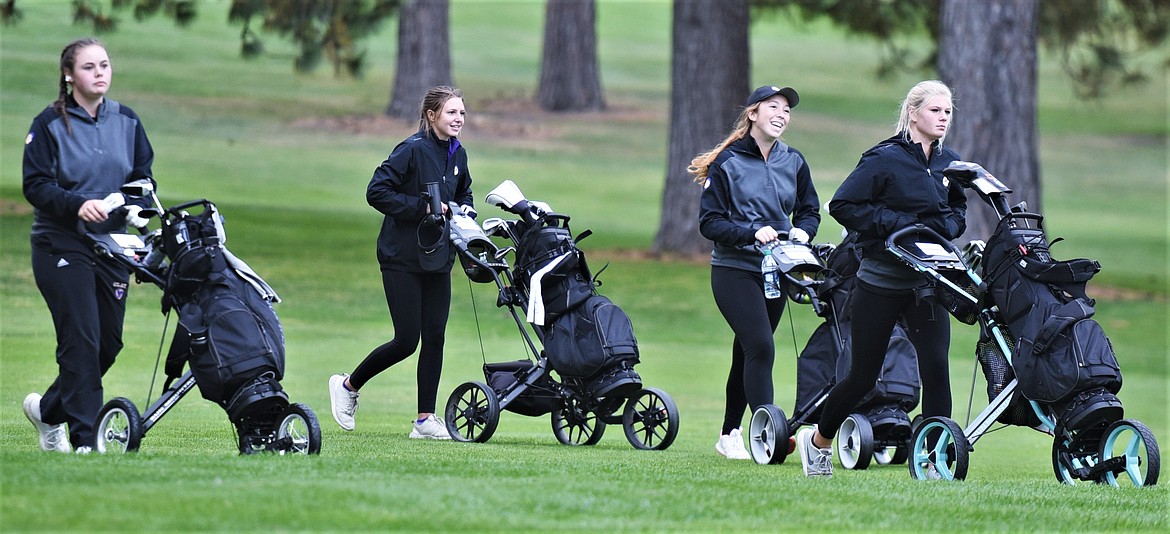 Four members of the Polson girls team walk down the No. 10 fairway. From left are Clare Konen, Ellie Thiel, Carly Garrick and Kylee Seifert. Not pictured: Ashley Maki. (Scot Heisel/Lake County Leader)