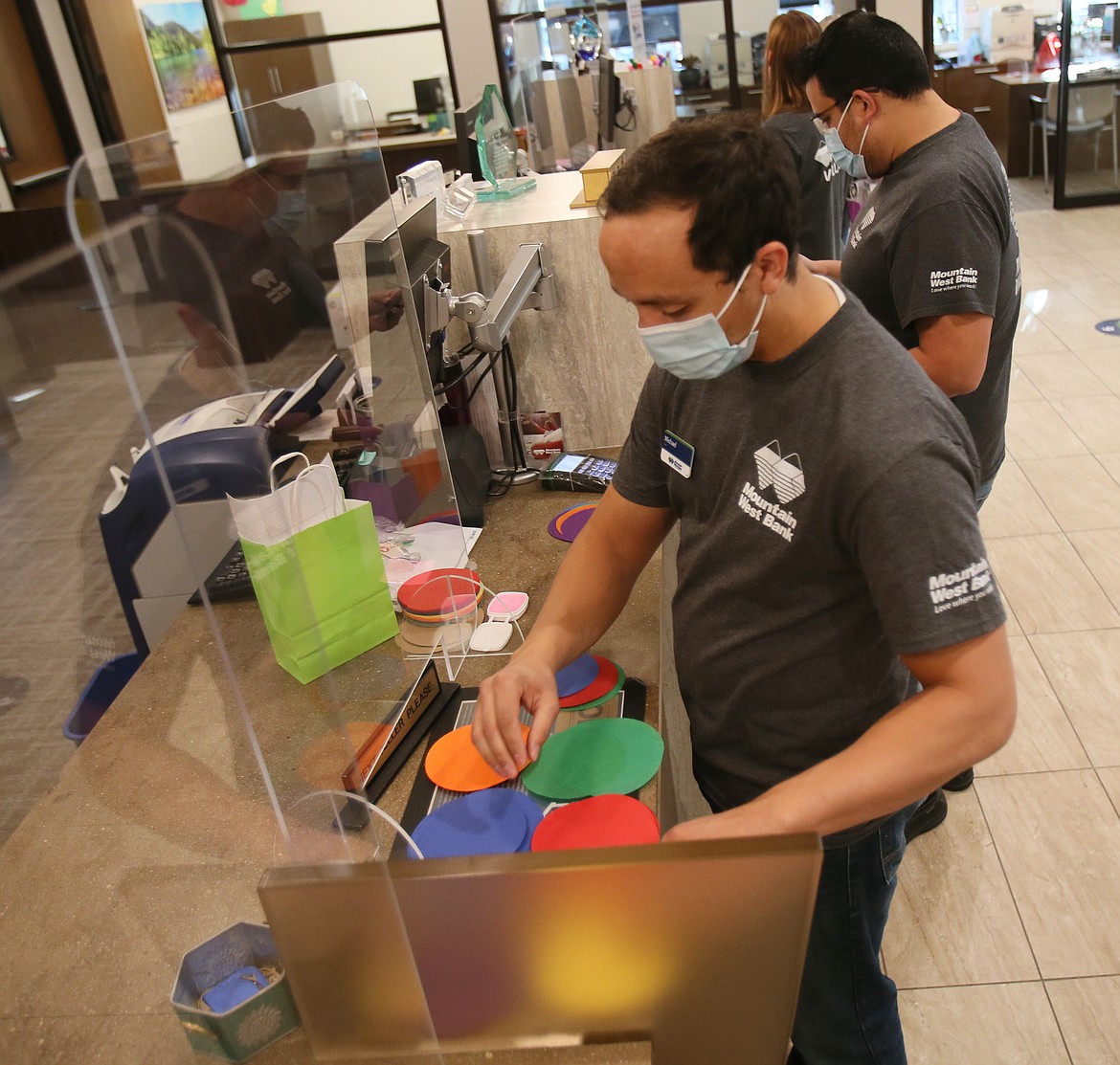 Mountain West Bank teller Michael Myatt on Tuesday morning prepares discs of colorful tissue paper to be delivered in project bags to Early Head Start as part of United Way's annual Day of Caring.