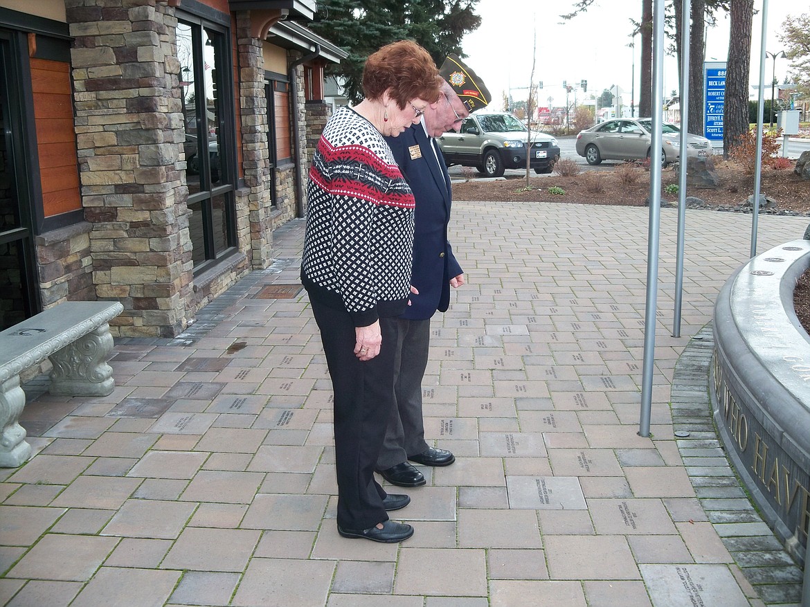 Carl Gidlund (right), stands alongside Emmett Sullivan in 2012 as the two veterans pay their respects to PFC Robert Gordon, a Hayden Lake Marine killed in action in Vietnam in 1969. The commemorative brick program that honors veterans is now available for those who wish to place a brick on the memorial plaza grounds in front of Hayden City Hall. (Courtesy of Suzanne Cano)