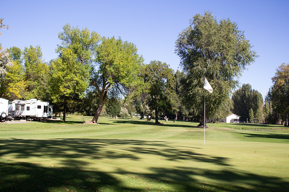 The sun shines through the branches onto the greens at Oasis RV Park & Golf Course in Ephrata.