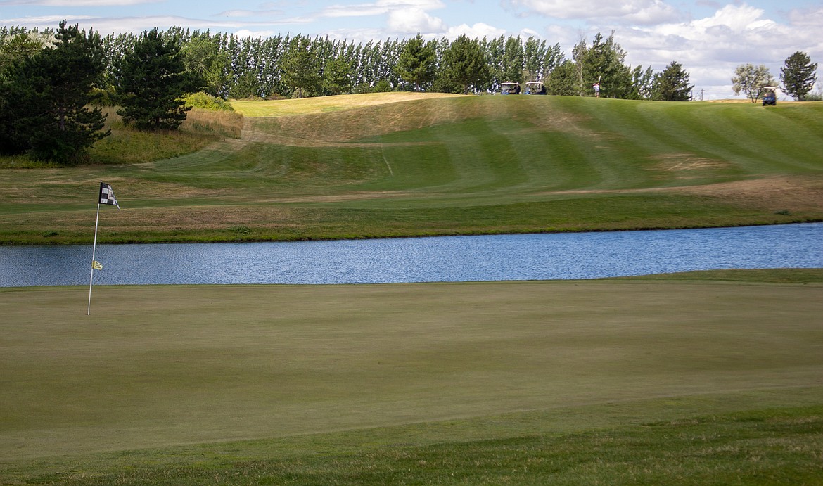 Golfers make their shot down Hole 9 towards the green at The Links at Moses Pointe over the summer in Moses Lake.