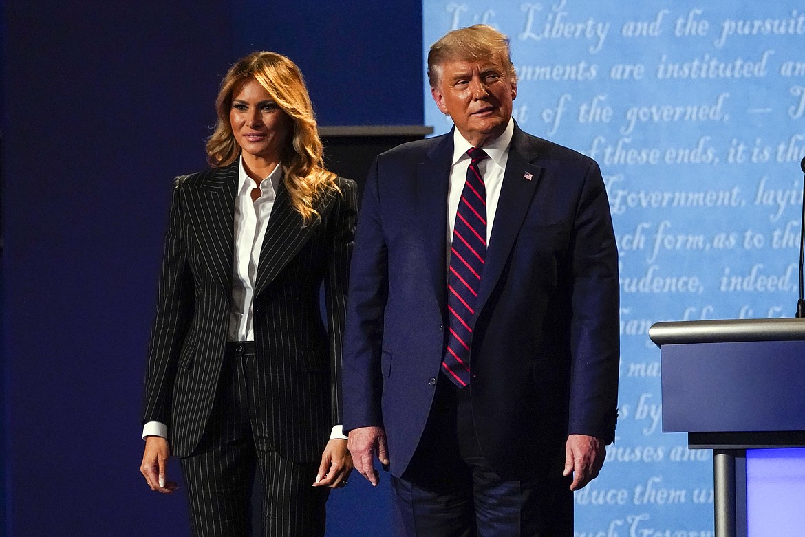 President Donald Trump stands on stage with first lady Melania Trump after the first presidential debate with Democratic presidential candidate former Vice President Joe Biden Tuesday, Sept. 29, 2020, at Case Western University and Cleveland Clinic, in Cleveland, Ohio. President Trump and first lady Melania Trump have tested positive for the coronavirus, the president tweeted early Friday. (AP Photo/Julio Cortez)