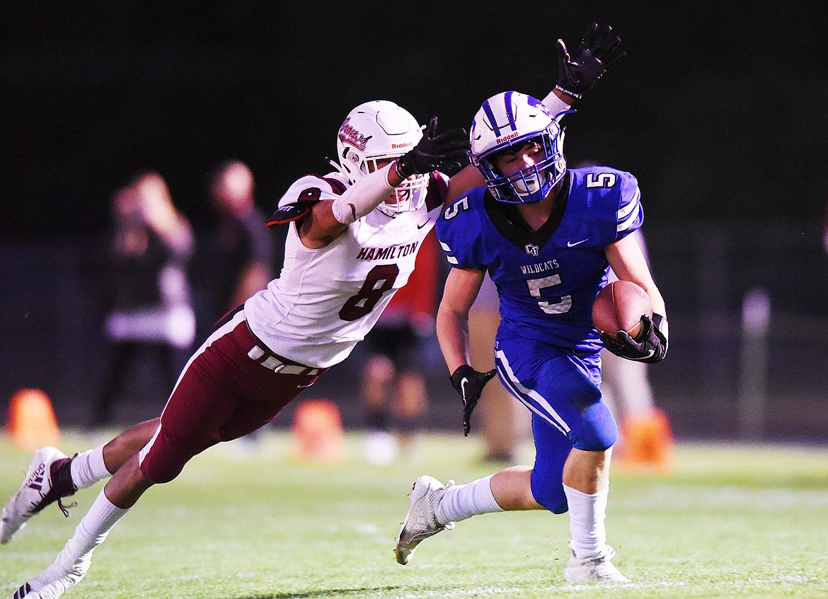 Columbia Falls running back Isaiah Roth (5) is brought down by Hamilton defensive back Tristan Lewis (8) on a second quarter run at Satterthwaite Memorial Field in Columbia Falls on Friday. (Casey Kreider/Daily Inter Lake)