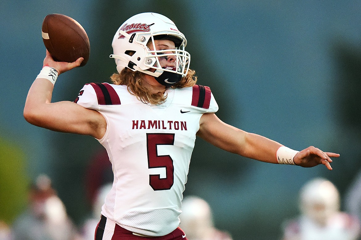 Hamilton quarterback Tyson Rostad (5) rolls out to pass in the first half against Columbia Falls at Satterthwaite Memorial Field in Columbia Falls on Friday. (Casey Kreider/Daily Inter Lake)