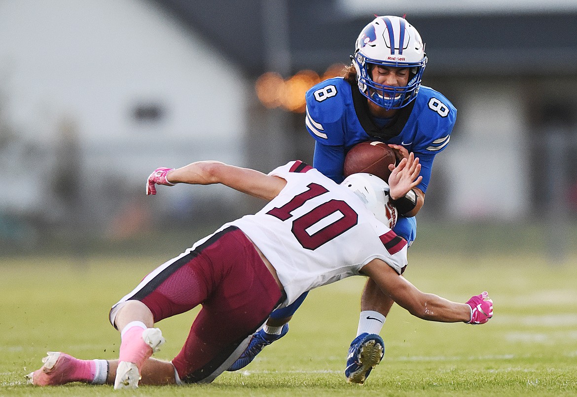 Columbia Falls quarterback Mason Peters (8) is brought down by Hamilton linebacker Tyler Glenn (10) after a first-quarter run at Satterthwaite Memorial Field in Columbia Falls on Friday. (Casey Kreider/Daily Inter Lake)