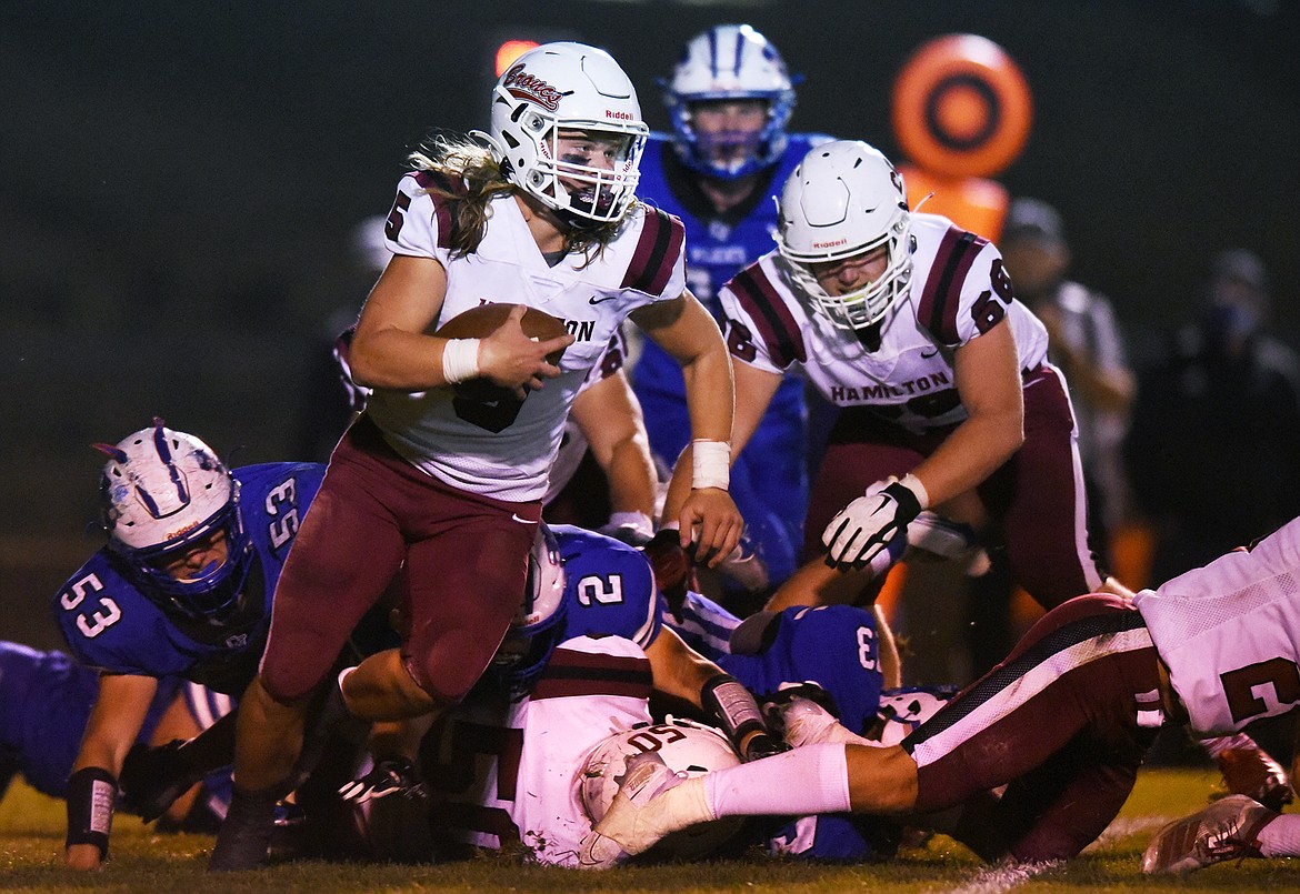 Hamilton quarterback Tyson Rostad (5) takes off running in the first half against Columbia Falls at Satterthwaite Memorial Field in Columbia Falls on Friday. (Casey Kreider/Daily Inter Lake)