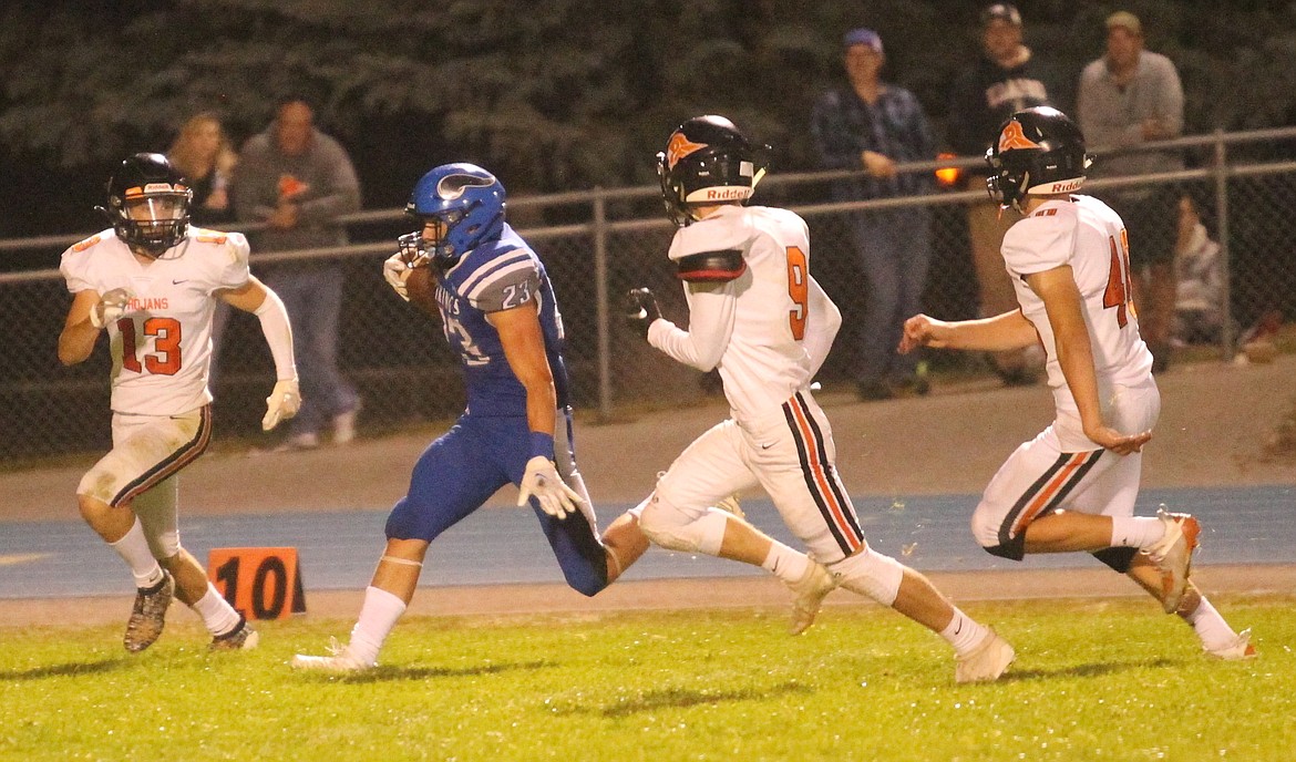 MARK NELKE/Press
Gunner Giulio of Coeur d'Alene avoids Post Falls defenders Tommy Hauser (13), Tristan White (9) and Ethan Miller to complete a 47-yard scoring pass play in the second half Friday night in Coeur d'Alene.