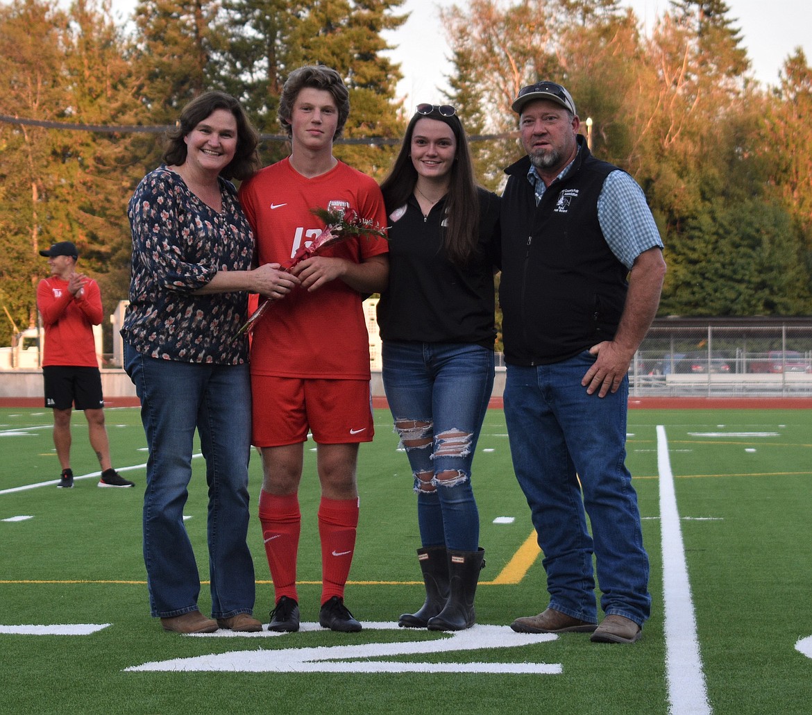 Kris Berget poses for a photo with his family on Senior Night.