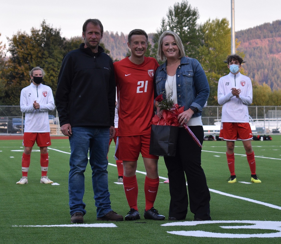 Taylor Beauchene poses for a photo with his family on Senior Night.