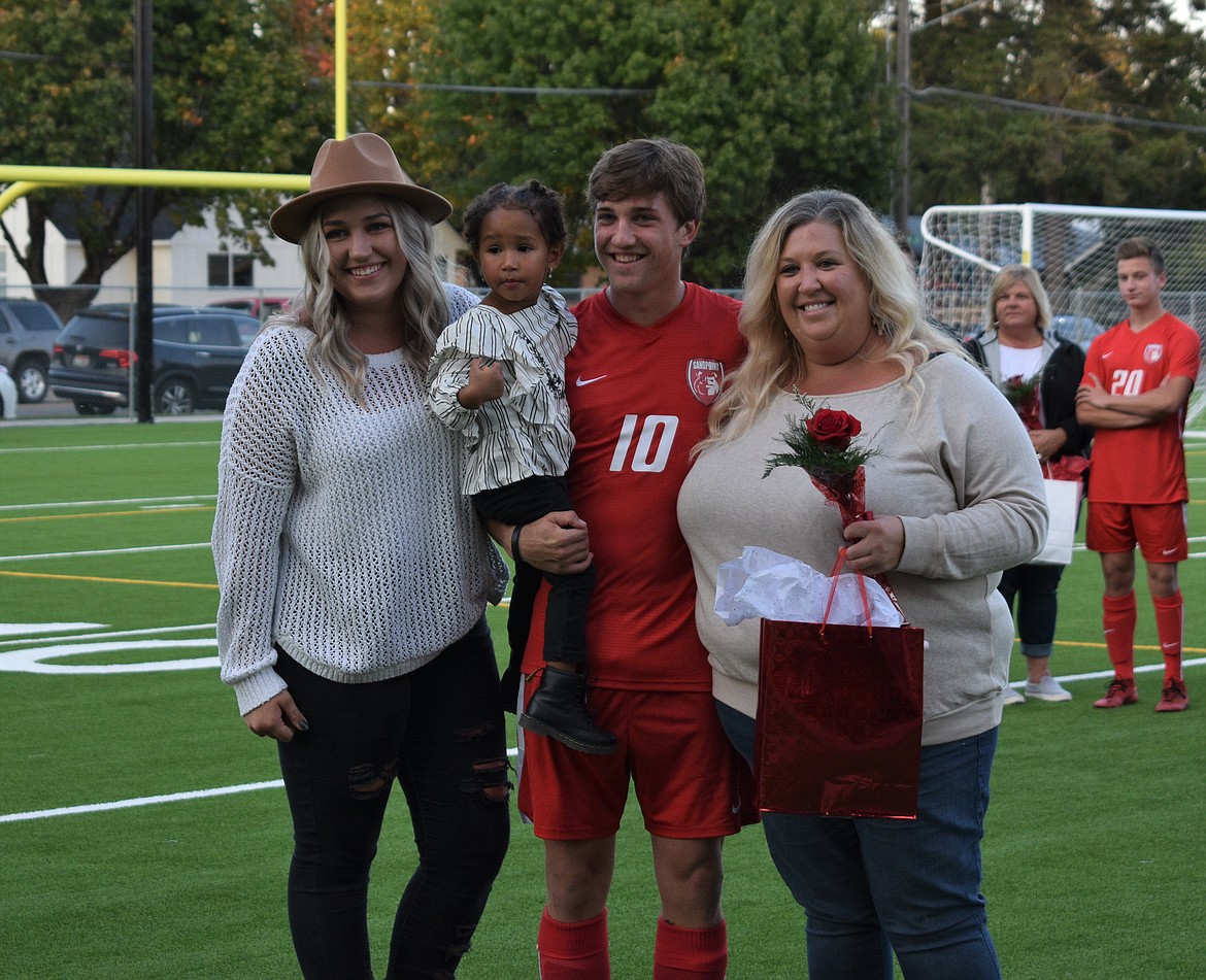 Zander Moore poses for a photo with his family on Senior Night.