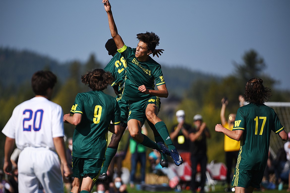 Whitefish’s Brandon Mendoza (8) and Marvin Kimera (22) celebrate after Kimera’s goal in the second half against Columbia Falls at Smith Fields in Whitefish on Saturday. (Casey Kreider/Daily Inter Lake)