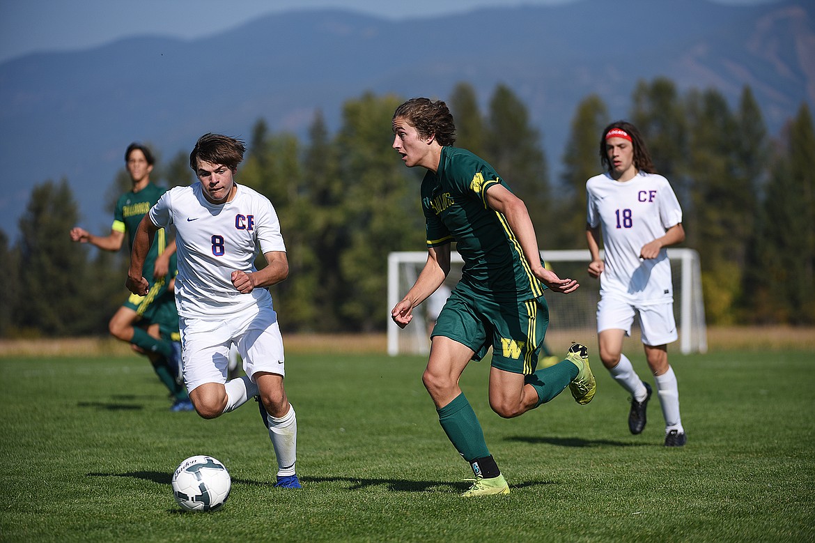 Whitefish’s Gabe Menicke (9) pushes the ball upfield with Columbia Falls’ Nico Lang (8) in pursuit at Smith Fields in Whitefish on Saturday. (Casey Kreider/Daily Inter Lake)