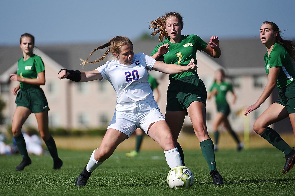 Columbia Falls’ Makayla Sevesind (20) battles for possession with Whitefish’s Brooke Roberts (2) in the second half at Smith Fields in Whitefish on Saturday. (Casey Kreider/Daily Inter Lake)
