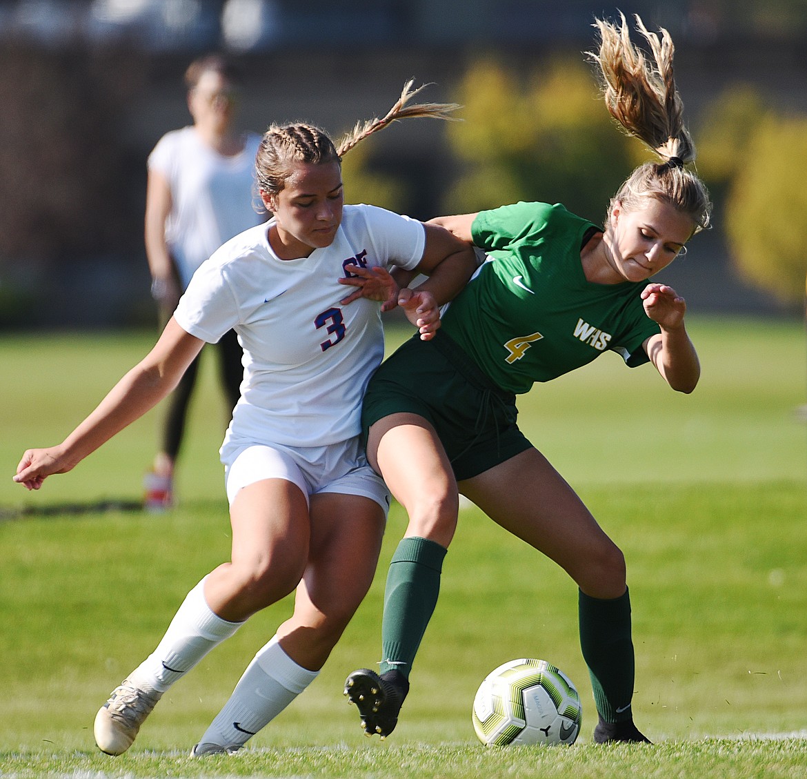 Columbia Falls’ Aletheia Fisher (3) and Whitefish’s Sophie Olson (4) battle for possession in the first half at Smith Fields in Whitefish on Saturday. (Casey Kreider/Daily Inter Lake)