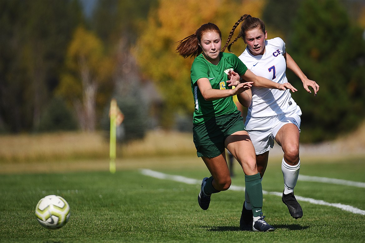 Whitefish’s Adrienne Healy (6) and Columbia Falls’ Maddie Robison (7) chase down a ball in the first half at Smith Fields in Whitefish on Saturday. (Casey Kreider/Daily Inter Lake)