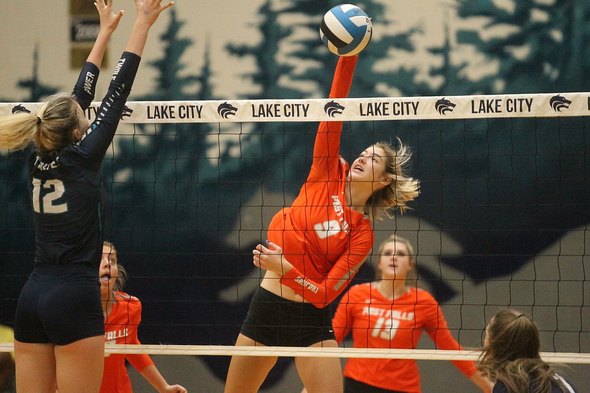 MARK NELKE/Press
Rylee Hartwig (9) of Post Falls hits past Brenna Hawkins of Lake City on Saturday at Lake City.