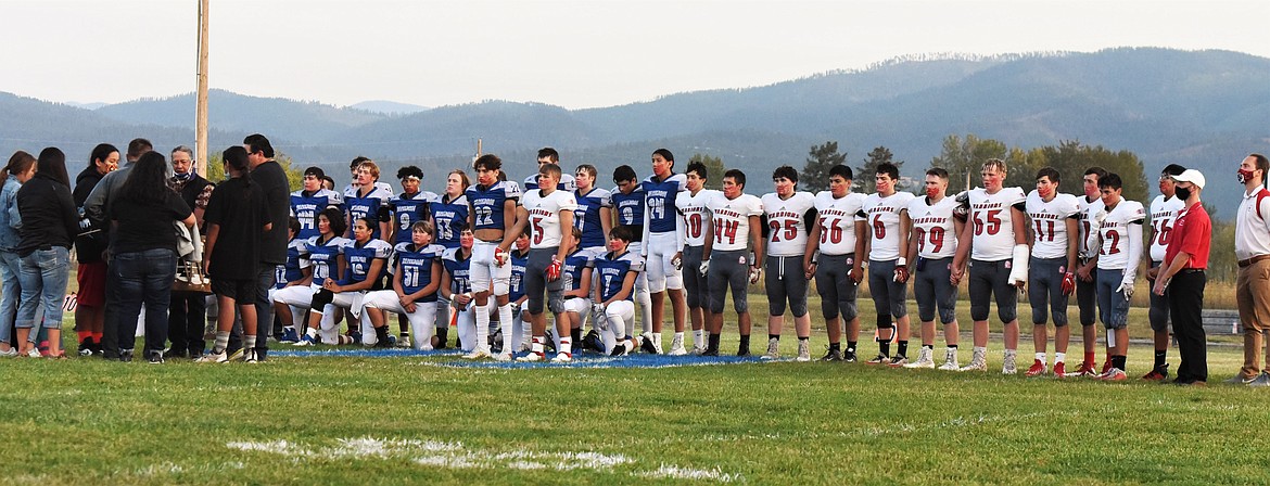 Both teams shared the field in a show of solidarity as Yamancut performed a song prior to kickoff. (Scot Heisel/Lake County Leader)