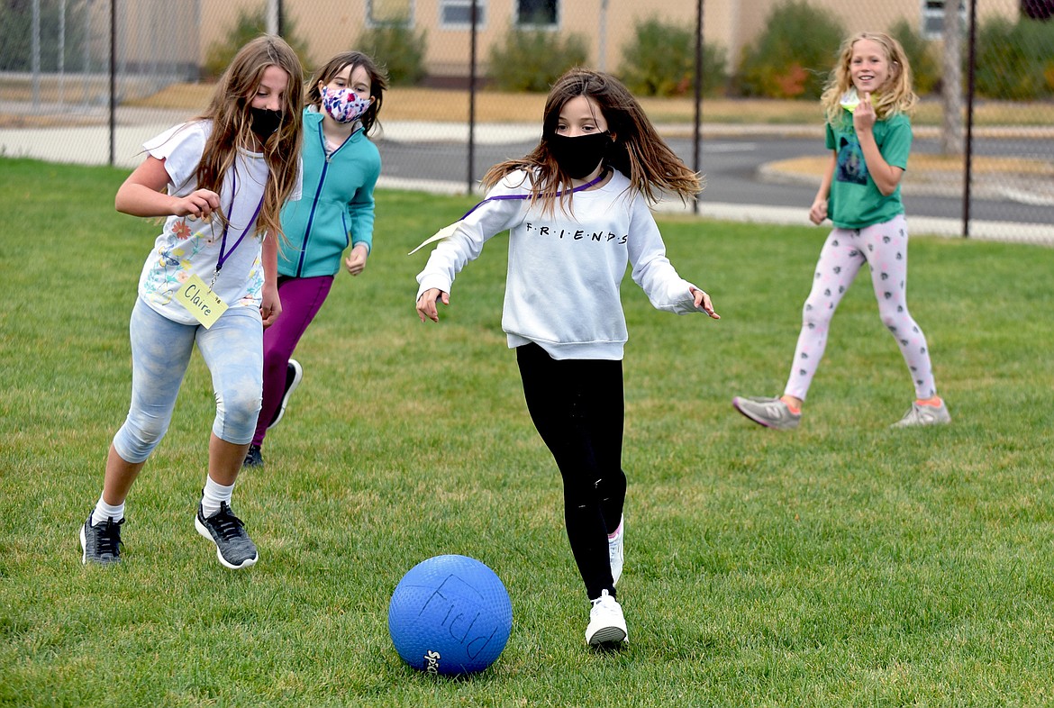 Muldown fourth graders play a game on the open field section of the playground at the elementary school. Pictured from left to right: Claire Graham, Bella Woodruff, Hayley Reardon and Avery Orme. (Whitney England/Whitefish Pilot)