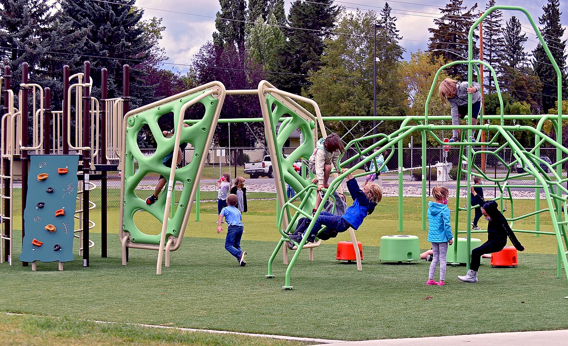 Muldown first graders play on the new playground outside of the elementary school. (Whitney England/Whitefish Pilot)