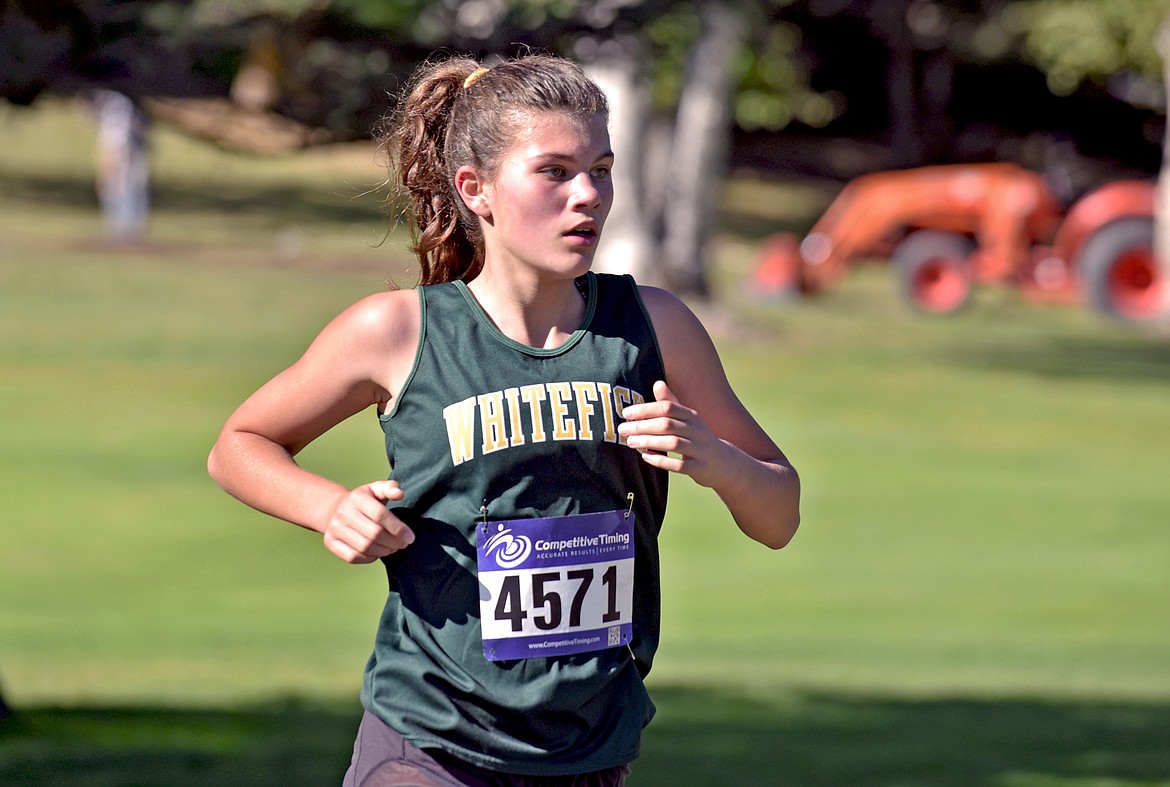 Bulldog freshman Raiya McCutcheon runs in the girls cross country varsity race at the Stumptown Triangular at Whitefish Lake Golf Club on Tuesday, Sept. 29. (Whitney England/Whitefish Pilot